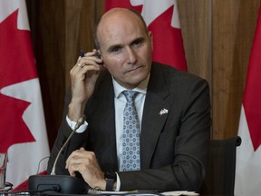 Health Minister Jean-Yves Duclos listens to a translation device as he is asked a question during a news conference, Monday, Sept. 26, 2022 in Ottawa.
