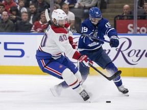 Calle Jarnkrok of the  Maple Leafs, forced to play defence in Wednesday's 3-0 pre-season win over the Habs because of early injuries, gets a stick up on Joel Armia. Alex Kerfoot also moved back to the blue line.