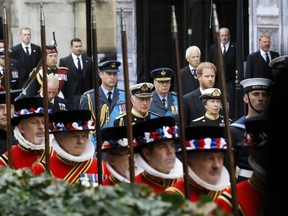 Prince William, Prince of Wales, Prince Richard, Duke of Gloucester, Prince Harry, King Charles III, and Princess Anne walk alongside Yeoman of the Guards at the State Funeral of Queen Elizabeth II, in London, Monday Sept. 19, 2022. (Tristan Fewings/Pool Photo via AP)