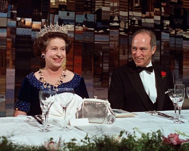 Prime Minister Pierre Trudeau is seated next to Queen Elizabeth II at an offical dinner he is hosting in the Queen's honor in Vancouver, B.C. March 10, 1983. (CP PHOTO/Peter Bregg)