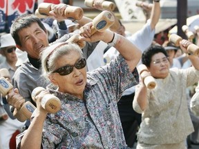 TOKYO, JAPAN: Elderly people workout with wooden weights at Koganji temple in Tokyo to celebrate Japan's Respect-for-the-Aged-Day on Sept. 19, 2005. September 2005,.