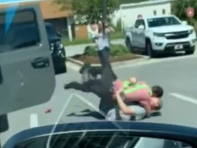 A screenshot from a video released by the twitter account for the Okaloosa Co. Sheriff's Office  - in Florida - @OCSOALERTS showing an alleged would-be carjacker being tackled.
