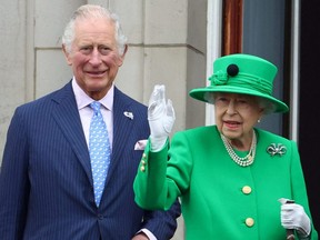 Britain's Queen Elizabeth and Prince Charles stand on a balcony during the Platinum Jubilee Pageant, marking the end of the celebrations for the Platinum Jubilee of Britain's Queen Elizabeth, in London, June 5, 2022.