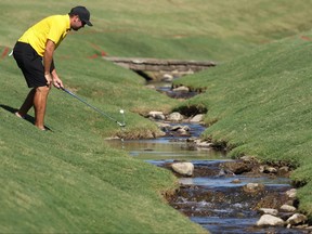 Canada’s Corey Conners of the International Team fishes his ball out of the water during a practice round at the Presidents Cup at Quail Hollow Country Club in Charlotte, N.C. yesterday.