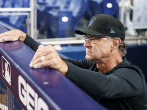 Marlins manager Don Mattingly looks out from the dugout before the start of a game against the Nationals at LoanDepot Park in Miami, Sunday, Sept. 25, 2022.