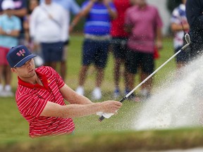 Sep 25, 2022; Charlotte, North Carolina, USA; Team USA golfer Sam Burns hits out of the bunker on the fourth hole during the singles match play of the Presidents Cup golf tournament at Quail Hollow Club.