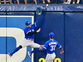 Blue Jays outfielder George Springer, left, can't make the catch on a ball hit by the Rays' Christian Bethancourt, resulting in an RBI double in the fourth inning at Tropicana Field in St Petersburg, Fla., Friday, Sept. 23, 2022.