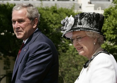 Britain's Queen Elizabeth II stands with US President George W. Bush during an official welcome ceremony, 07 May 2006 on the South Lawn of the White House in Washington, DC. The queen last visited the United States in 1991 when Bush's father was president. (TIMOTHY A. CLARY/AFP via Getty Images)