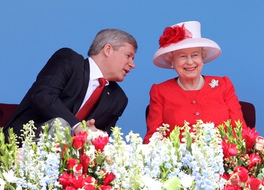 Queen Elizabeth II and Prime Minister of Canada Stephen Harper arrive on stage for the Canada Day celebrations on Parliament Hill on July 1, 2010 in Ottawa, Canada. (Chris Jackson/Getty Images)