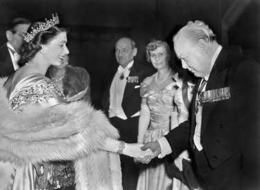 The Princess Elizabeth of Great Britain greets Winston Churchill at a Guildhall reception, 23 March 1950 in London. In the background can be seen the Prime Minister Mr Atlee and his wife Mrs Atlee. (AFP via Getty Images)