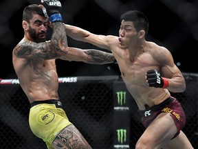 Elizeu dos Santos of Brazil punches Li Jingliang of China in their welterweight bout during the UFC Fight Night event at Shenzhen Universiade Sports Centre on August 31, 2019 in Shenzhen, China.