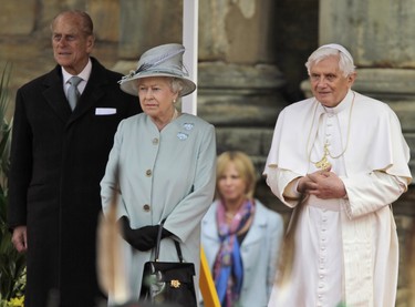 Britain's Queen Elizabeth II, (C) Pope Benedict XVI (R) and Prince Philip (L) inspect a honour guard by members of the Royal Company of Archers and members of the Royal Regiment of Scotland Band as the Pope arrives at the Palace of Holyroodhouse, in Edinburgh, Scotland, on September 16, 2010. Pope Benedict XVI arrived in Britain on Thursday at the start of an historic four-day state visit, after admitting the Catholic Church had not been vigilant enough on paedophilia. (LEFTERIS PITARAKIS/POOL/AFP via Getty Images)
