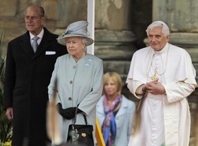 Britain's Queen Elizabeth II, (C) Pope Benedict XVI (R) and Prince Philip (L) inspect a honour guard by members of the Royal Company of Archers and members of the Royal Regiment of Scotland Band as the Pope arrives at the Palace of Holyroodhouse, in Edinburgh, Scotland, on September 16, 2010. Pope Benedict XVI arrived in Britain on Thursday at the start of an historic four-day state visit, after admitting the Catholic Church had not been vigilant enough on paedophilia. (LEFTERIS PITARAKIS/POOL/AFP via Getty Images)