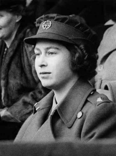 Princess Elizabeth of York appears for the first time wearing a uniform, on April 8, 1945, at the Wembley stadium to attend the Football League South Cup Final match. (PLANET NEWS/AFP via Getty Images)