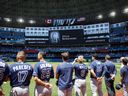 Tampa Bay Rays players and staff observe a moment of silence at the death of Julia Budzinski, the eldest daughter of first base coach Mark Budzinski, before a game against the Tampa Bay Rays at Rogers Center on 3 July 2022 in Toronto, Canada.  