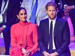 Britain's Meghan, Duchess of Sussex (L) and Britain's Prince Harry, Duke of Sussex, attend the annual One Young World Summit at Bridgewater Hall in Manchester.