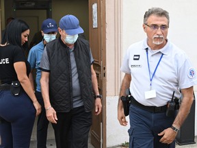 French ex-dentists Lionel (back) and his father Carnot Guedj (2nd R), accused of fraud and dental mutilation arrive at the courthouse on the trial voting and sentencing's day in Marseille, southern France, on September 8, 2022. (Photo by CHRISTOPHE SIMON/AFP via Getty Images)