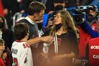 Tom Brady #12 of the Tampa Bay Buccaneers celebrates with Gisele Bundchen after winning Super Bowl LV at Raymond James Stadium on February 07, 2021 in Tampa, Florida. (Photo by Mike Ehrmann/Getty Images)