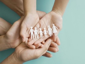 Hands holding multi generation family paper, family wellness, health insurance concept