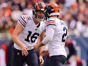 Cairo Santos #2 of the Chicago Bears celebrates with Trenton Gill #16 after kicking a field goal against the Houston Texans at Soldier Field on September 25, 2022 in Chicago, Illinois.