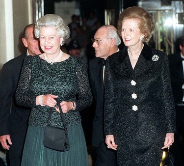 Britain's Queen Elizabeth II (L) and former British Prime Minister Thatcher arrive 16 October 1995 at Claridge's in London for a dinner to celebrate the former Prime Minister's 70th birthday. Baroness Thatcher greeted the Queen warmly, laying to rest past speculation that the two women did not get on with each other. (ADAM BUTLER/POOL/AFP via Getty Images)