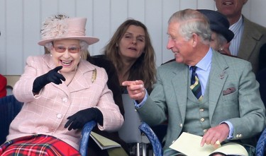Queen Elizabeth II and Prince Charles, Prince of Wales laugh as they watch the sack race at the annual Braemer Highland Games at The Princess Royal and Duke of Fife Memorial Park on September 7, 2013 in Braemar, Scotland. (Chris Jackson/Getty Images)