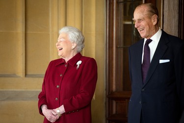Britain's Queen Elizabeth II and Prince Philip, Duke of Edinburgh react as they bid farewell to Irish President Michael D. Higgins and his wife Sabina (not pictured) at the end of their official visit at Windsor Castle on April 11, 2014 in Windsor, United Kingdom. (Leon Neal-WPA Pool/Getty Images)