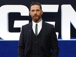 Actor Tom Hardy poses for pictures on the blue carpet at 'Legend' premiere.
