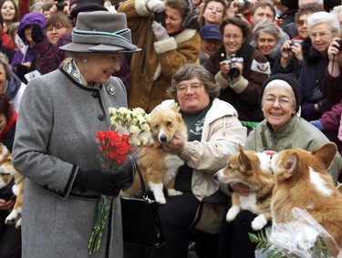 Queen Elizabeth II talks with members of the Manitoba Corgi Association during a visit to Winnipeg 08 October 2002. The queen, making her 20th trip to Canada, is the last stop on the year-long jubilee tour celebrating her 50-year reign.  (ADRIAN WYLD/AFP via Getty Images)