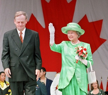 Her Royal Highness Queen Elizabeth II waves as she leaves the stage with Canadian Prime Minister Jean Chretien (L) after watching Canada Day celebrations on Parliment Hill in Ottawa, Canada 01 July. The Queen is on the ninth day of her ten day official visit to Canada.                       (CARLO ALLEGRI/AFP via Getty Images)