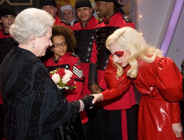 Britain's Queen Elizabeth II (L) meets American singer Lady Gaga (R) following the Royal Variety Performance in Blackpool, England on December 7, 2009. Returning to the town for the first time since 1955, the annual show features a wide range of artists from all aspects of popular entertainment and showbusiness. (LEON NEAL/AFP via Getty Images)