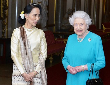 Britain's Queen Elizabeth II greets Myanmar's de facto leader Aung San Suu Kyi (L) ahead of a private lunch at Buckingham Palace in London on May 5, 2017. (JOHN STILLWELL/AFP via Getty Images)