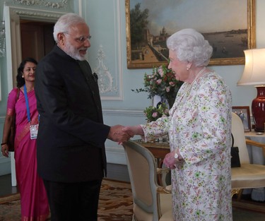 India's Prime Minister Narendra Modi is greeted by Britain's Queen Elizabeth II during a private audience at Buckingham Palace in London on April 18, 2018. (YUI MOK/POOL/AFP via Getty Images)