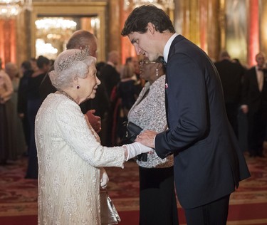 Britain's Queen Elizabeth II greets Canada's Prime Minister Justin Trudeau (R) in the Blue Drawing Room during a drinks reception before The Queen's Dinner during The Commonwealth Heads of Government Meeting (CHOGM), at Buckingham Palace in London on April 19, 2018. (VICTORIA JONES/POOL/AFP via Getty Images)