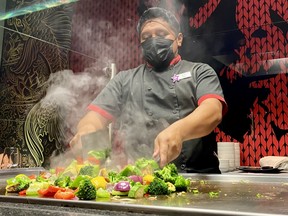 The chef shows off his knife skills at the hibachi grill at East Sushi and Teppanyaki Bar. CYNTHIA MCLEOD/TORONTO SUN