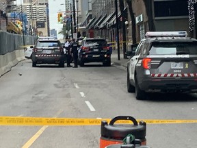 Toronto Police vehicles are pictured at the scene of a fatal hit-and-run near Yonge and College Sts. on Sept. 5, 2022.