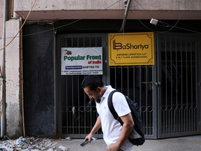 A man walks past the old office of Popular Front of India (PFI) Islamic group, in New Delhi, India, September 28, 2022.