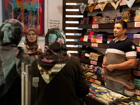 Women shop for scarves of Iranian scarf brand Devora at Kourosh mall in western Tehran, Iran June 22, 2019.