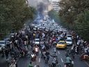 A picture obtained by AFP outside Iran on Wednesday, Sept. 21, 2022, shows Iranian demonstrators taking to the streets of the capital Tehran during a protest for Mahsa Amini, days after she died in police custody.
