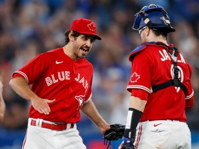 Blue Jays reliever Jordan Romano (left) and Danny Jansen celebrate a 3-2 win over the Tampa Bay Rays at Rogers Centre on Sept. 12, 2022.