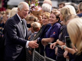 Britain's King Charles III greets well-wishers as he arrives at Hillsborough Castle in Belfast on Tuesday, Sept. 13, 2022, during his visit to Northern Ireland.