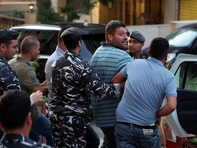 Jawad Slim, the man who held up an LGB Bank branch seeking his own savings, is escorted by police as he leaves the bank, in Ramlet al-Bayda area in Beirut, Lebanon September 16, 2022.