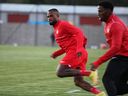 Canada's Cyle Larin, left, and Jonathan David take part in a national team training session at MOL Football Academy in Bratislava, Slovakia on Sept. 20, 2022.