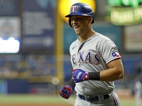 Nathaniel Lowe of the Texas Rangers is congratulated after hitting a two run home run in the third inning during a game against the Texas Rangers at Tropicana Field on Sept. 16, 2022 in St Petersburg, Fla.