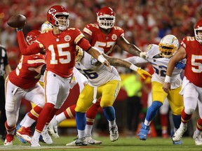 Patrick Mahomes of the Kansas City Chiefs scrambles and throws the ball for a touchdown during the third quarter against the Los Angeles Chargers at Arrowhead Stadium on Sept. 15, 2022 in Kansas City, Mo.