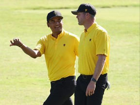 Sebastian Munoz of Colombia and the International Team and Taylor Pendrith of Canada walk together during a practice round prior to the 2022 Presidents Cup at Quail Hollow Country Club on Wednesday.