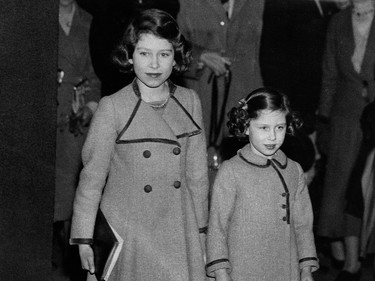 Picture taken on March 12, 1937 showing Princesses Elizabeth (L)and Margaret leaving the Royal Agricultural Hall after watching the competitions at the Pony Show. (Photo by - / CENTRAL PRESS PHOTO LTD / AFP) (Photo by -/CENTRAL PRESS PHOTO LTD/AFP via Getty Images)