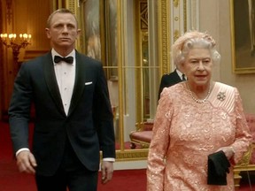 In this file TV screen grab image taken July 29, 2012, shows footage featured during the Opening Ceremony of the London 2012 Olympic Games starring British actor Daniel Craig (left) playing James Bond escorting Britain's Queen Elizabeth II through the corridors of Buckingham Palace.