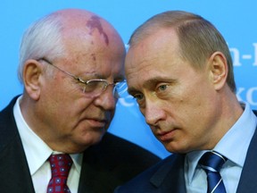 Russian President Vladimir Putin, right, listens to former President of the Soviet Union Mikhail Gorbachev during a news conference following bilateral talks with German Chancellor Gerhard Schroeder at Schloss Gottorf Palace in the northern German town of Schleswig, Germany, Dec. 21, 2004.