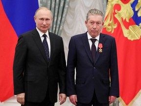 Russia’s President Vladimir Putin, left, and Ravil Maganov, who was chairman of the board of directors of Oil Company Lukoil, pose for a photo during an awarding ceremony at the Kremlin in Moscow on Nov. 21, 2019.